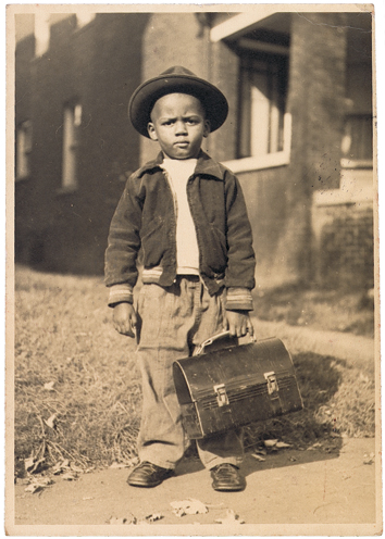 Photograph of boy with lunchbox