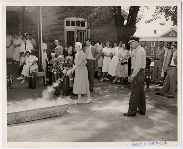 Nurse demonstrates the use of a fire extinguisher