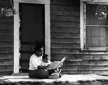 Women reading to a child in her lap