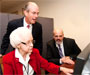 Goochland Clerk of Circuit Court Lee Turner (seated) navigates the digital collection as Frank Hargrove (standing), Clerk of Circuit Court in Hanover County and President of the Virginia Circuit Court Clerks' Association, and Carl Childs look on.