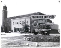 The Belgian Friendship Building: a gift of the Belgian Government, houses the gymnasium-auditorium (named Barco-Stevens Hall in memory of two veteran teachers: Dr. John W. Barco and Professor Wesley A. Stevens), Vann Tower (named after Robert L. Vann, an alumnus and founder of the Pittsburgh Courier), and the William J. Clark Hall, former library and current theatre. The facility was an exhibit in the 1939 New York World’s Fair. It was reconstructed on the campus in 1941. The history of Virginia Union University is the history of four distinct schools whose mergers through the years have defined the "Union" in our university's name. Erected by the Class of 1938, these signs tell the story. Date: ca. 1960. Photographer: Scott L. Henderson.