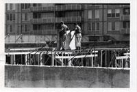 Two workmen at Crystal Plaza, on concrete building forms.  Date:  October 23, 1967. Photographer: Unknown, but worked for Arlington County.