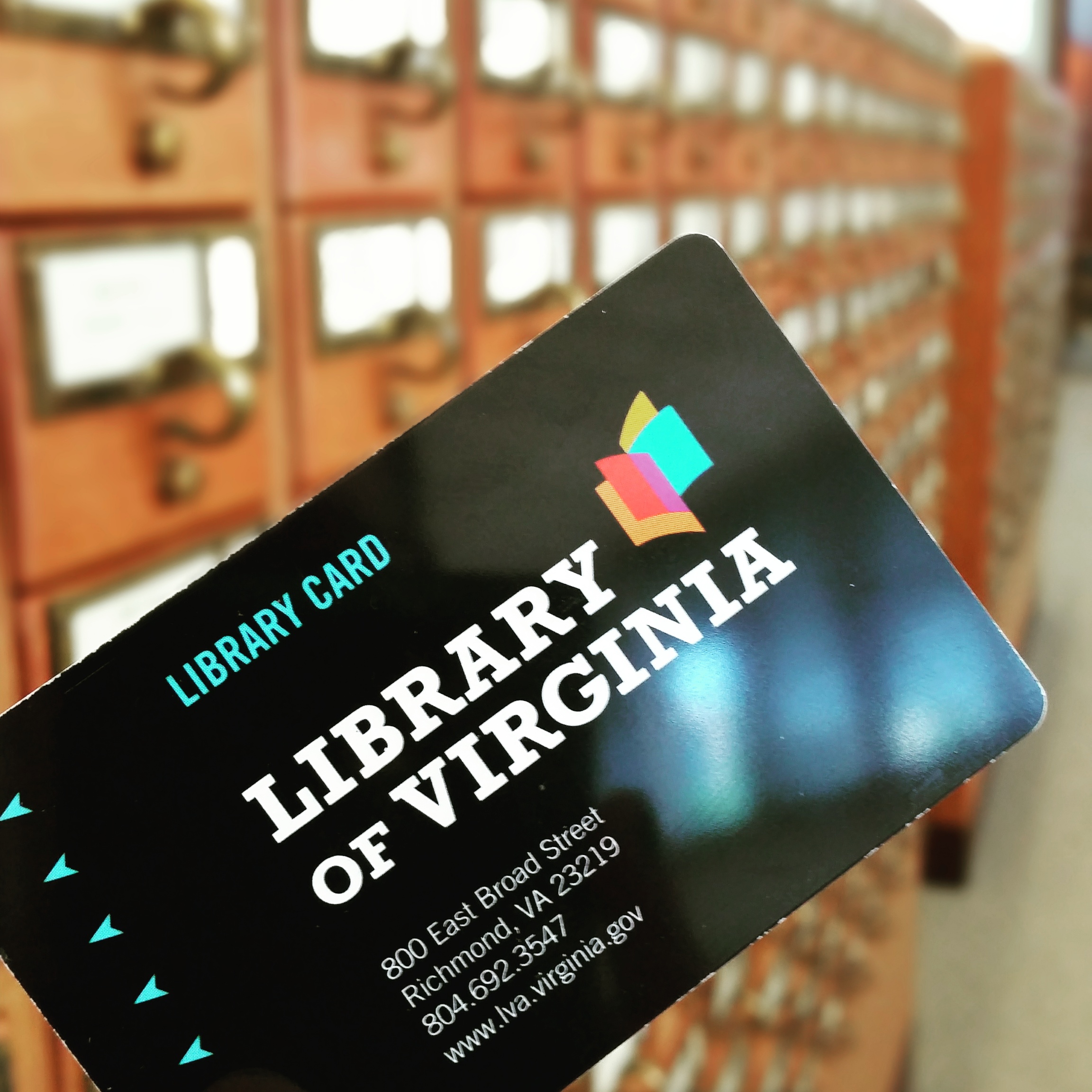Library of Virginia card held in front of a card catalog