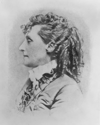 Side view photograph of an older white woman wearing late 19th century attire.