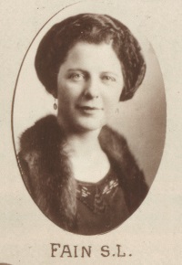 Headshot of a white woman wearing early 20th century attire.