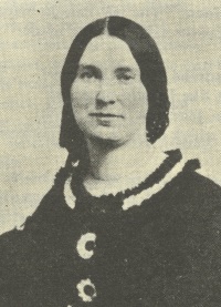 Headshot of a white woman wearing 19th century attire.