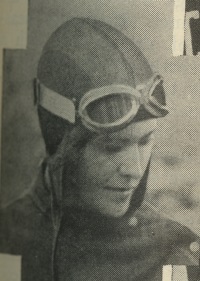 A white woman wearing aviator gear and goggles on her head