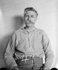 mug shot of a white man with a mustache