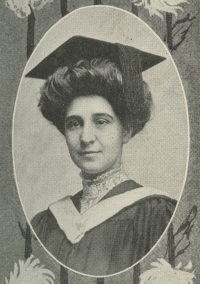 headshot of a white woman in a graduation cap and gown.