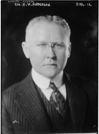 headshot of a white man wearing a suite and tie.