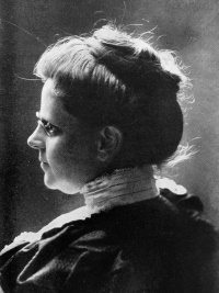 Side view portrait of a white woman wearing late 19th century attire.