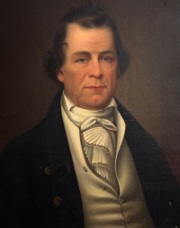 Oil portrait of a white man wearing 19th century attire.
