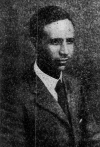 Newspaper photograph of an African American man wearing a suit and tie.