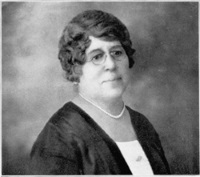 Headshot of an African American woman wearing glasses in early 20th century attire.