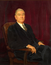 Oil portrait of a seated white man wearing a suit and tie.