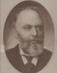 Headshot of a white man with a beard.