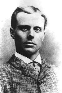 Headshot of a young white man wearing a suit.