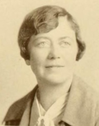 Headshot of a white woman wearing mid-20th century attire.