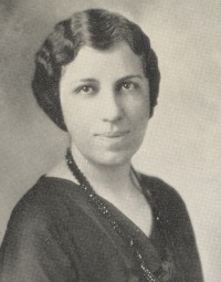 Headshot of a white woman wearing 1920s attire.