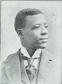 Profile photograph of an African American man wearing a suit and tie.