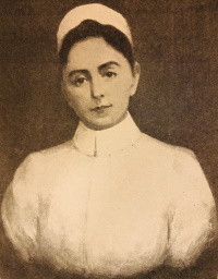 Portrait of a white woman in a nurses cap and uniform.
