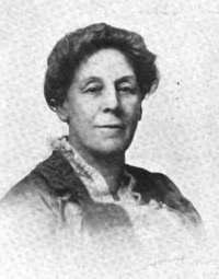Headshot of a white woman wearing early 20th century attire.