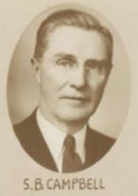 Headshot of a white man wearing a suit and tie.