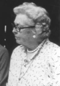Candid photograph of an older white woman wearing glasses.