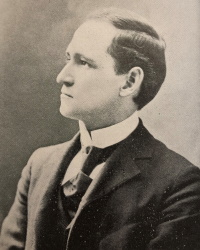 Profile photograph of a white man in early 20th century attire.