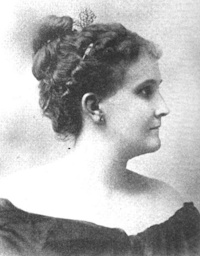 side view portrait of a white woman wearing early 20th century attire.