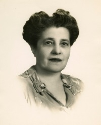 Headshot of a white woman wearing mid-20th century attire.