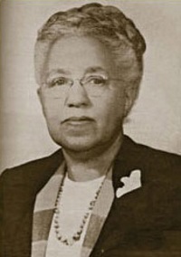 Headshot of an African American woman with glasses wearing mid-20th century attire.