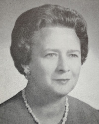 Headshot of a white woman wearing mid-20th century attire.