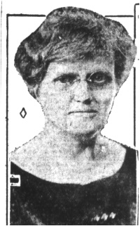 Newspaper photograph of a white woman wearing glasses.