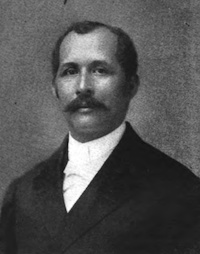 African American man with a mustache wearing late 19th-century attire.