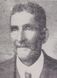 African American man with a mustache wearing early 20th century attire.