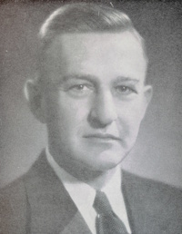 Headshot of a white man wearing mid-20th century attire.