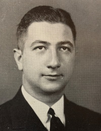 Headshot of a white man wearing a suit and tie.