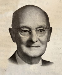 Headshot of a white man wearing glasses.