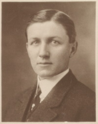 Headshot of a white man wearing early 20th century attire.