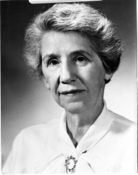 Headshot of a white woman wearing late 20th century attire.