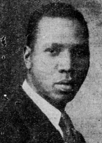 Newspaper photograph of an African American man wearing a suit and tie.