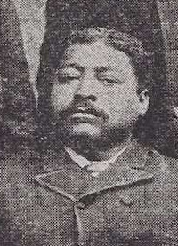 African American man with a mustache wearing late 19th century attire.