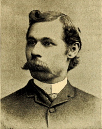 Headshot of an African American man with a mustache wearing late 19th century attire.