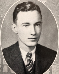 Yearbook photograph of a young white man in a suit and tie.