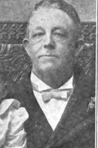 Headshot of a white man wearing early 20th century attire.