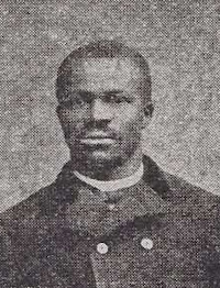African American man with a mustache wearing late 19th century attire.