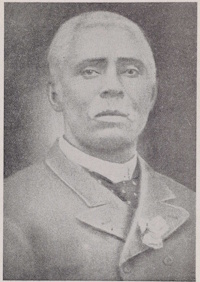 African American man with a mustache wearing early 20th century attire.