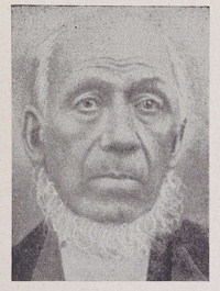 An African American man with a beard wearing late 19th century attire.