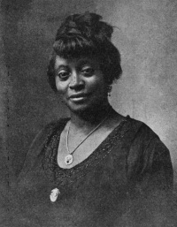 Studio photograph of an African American woman wearing early 20th century attire.
